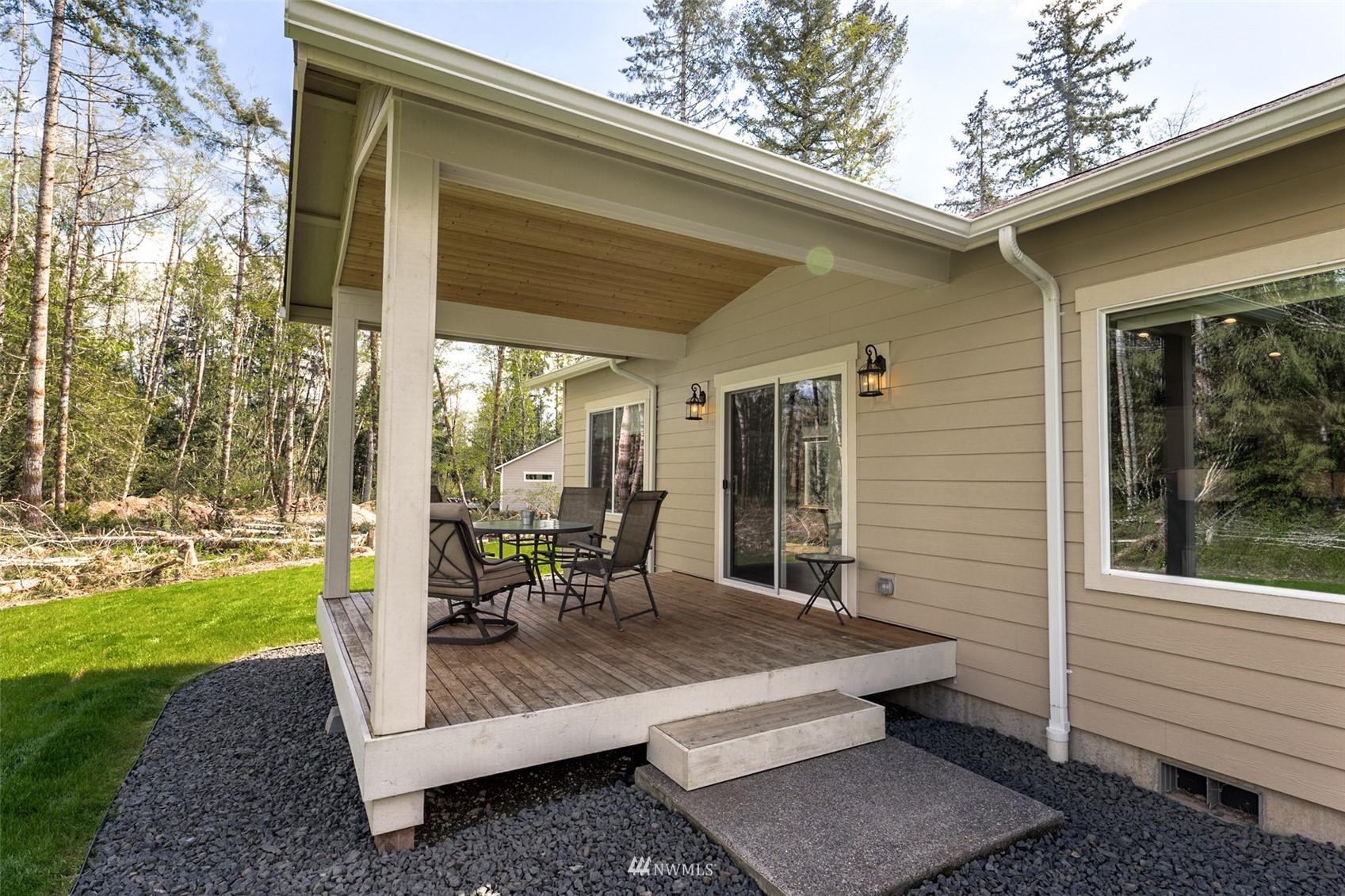 81 East Lighthouse Road Shelton, WA 98584 - Photo 20 of 28 a view of a patio with table and chairs and potted plants