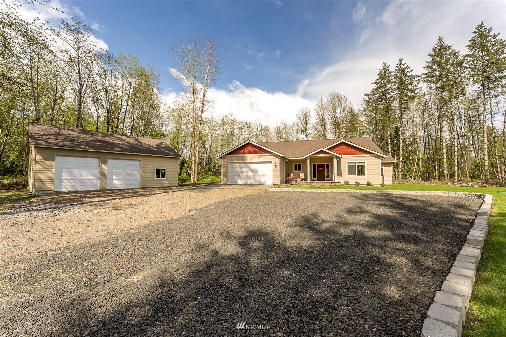 81 East Lighthouse Road Shelton, WA 98584 - Photo 2 of 28 a front view of a house with a yard and garage