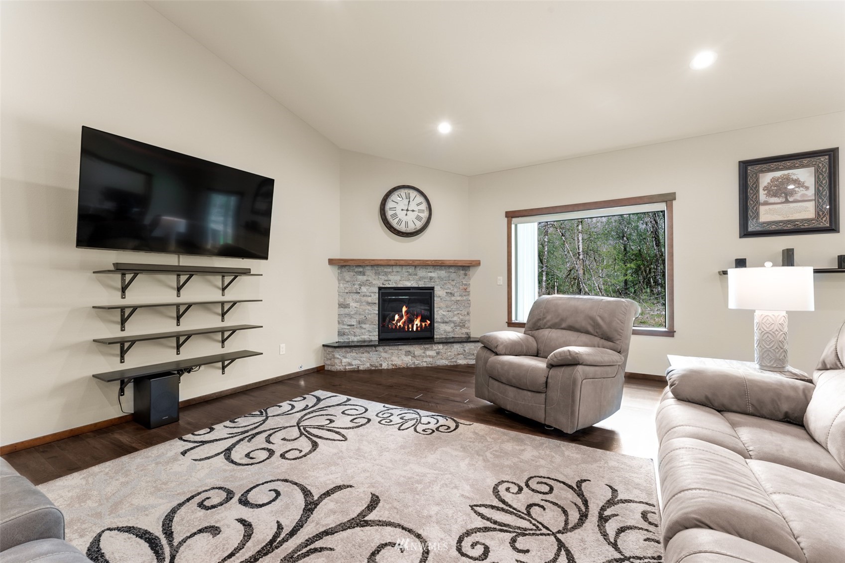 81 East Lighthouse Road Shelton, WA 98584 - Photo 6 of 28 a living room with furniture a flat screen tv and a fireplace