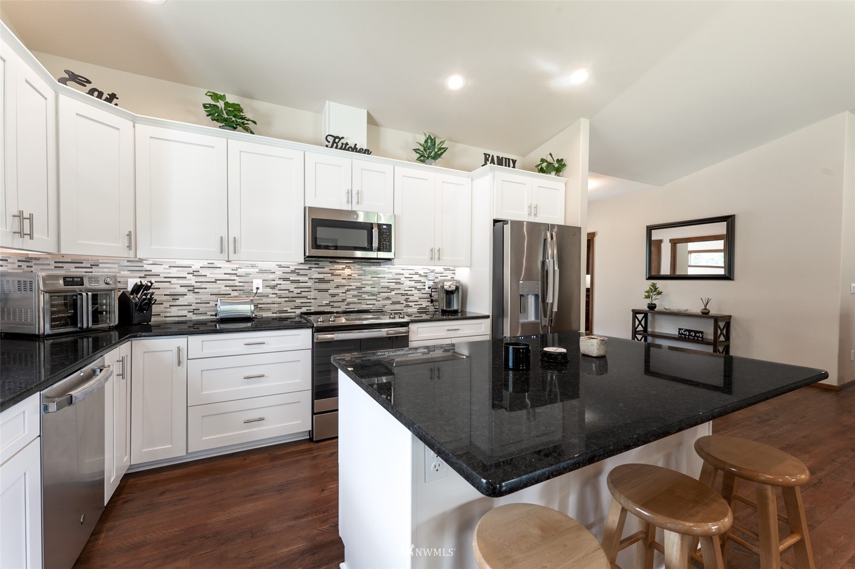 81 East Lighthouse Road Shelton, WA 98584 - Photo 8 of 28 a kitchen with stainless steel appliances granite countertop a stove refrigerator a sink dishwasher with a dining table and chairs