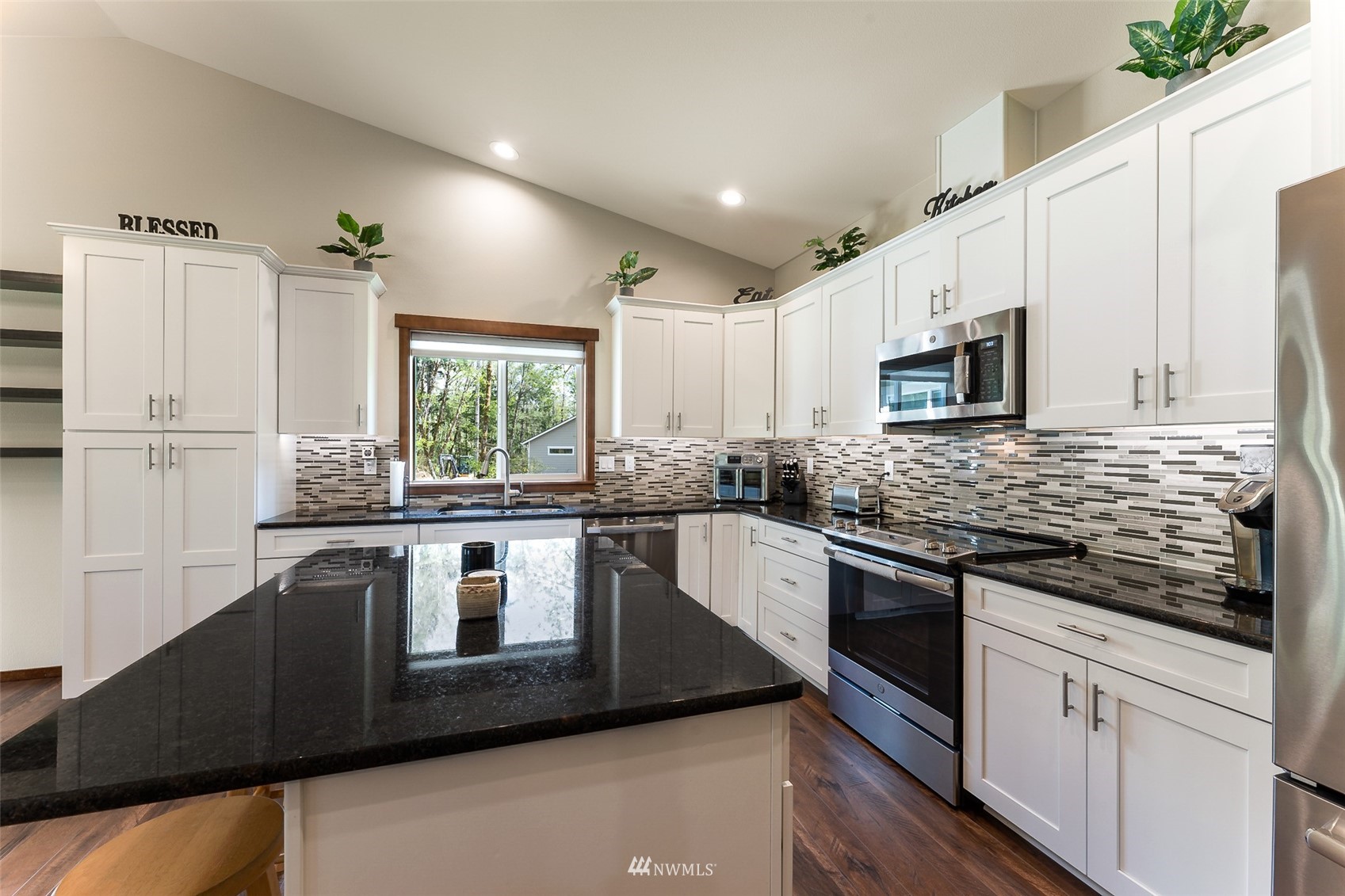 81 East Lighthouse Road Shelton, WA 98584 - Photo 9 of 28 a kitchen with kitchen island granite countertop white cabinets white stainless steel appliances with a sink and dishwasher