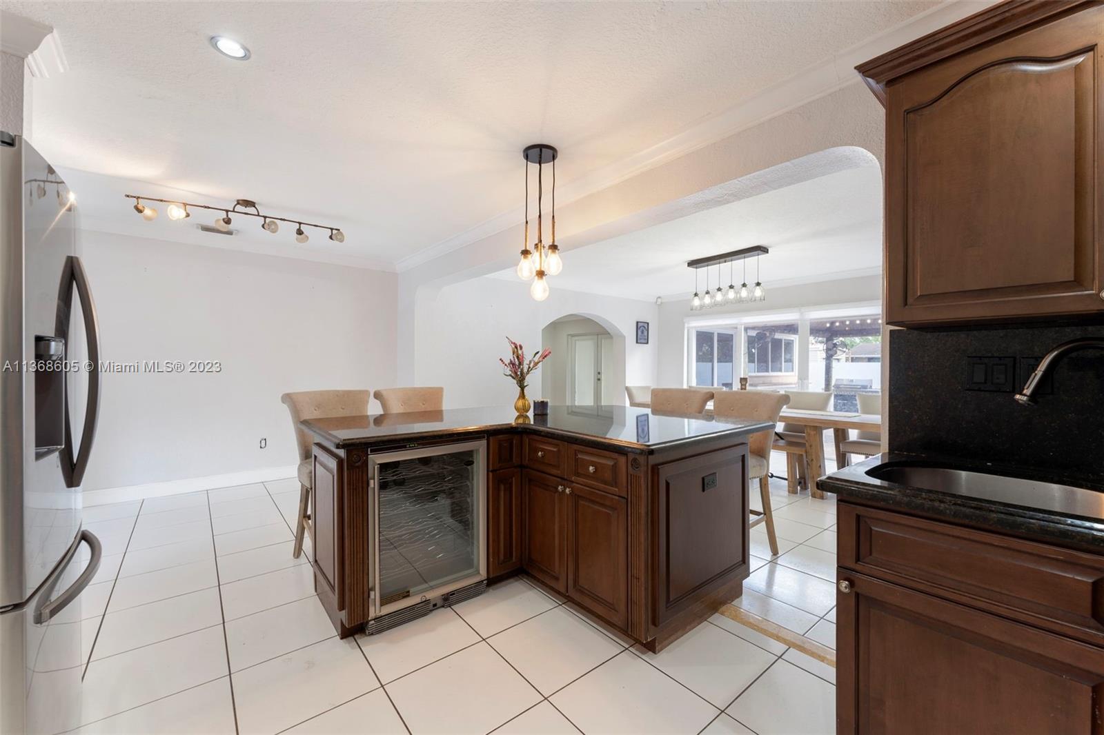Hialeah Hialeah, FL 33014 - Photo 11 of 32 a kitchen with stainless steel appliances granite countertop a sink and a refrigerator