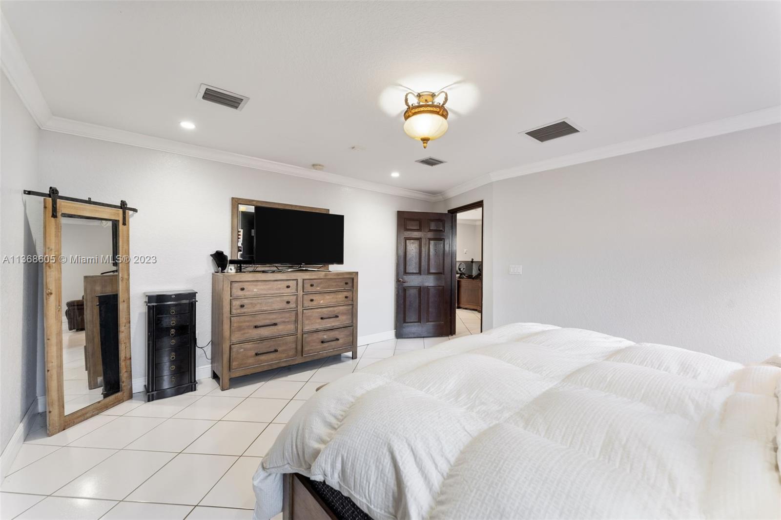 Hialeah Hialeah, FL 33014 - Photo 12 of 32 a bedroom with a bed and a flat screen tv