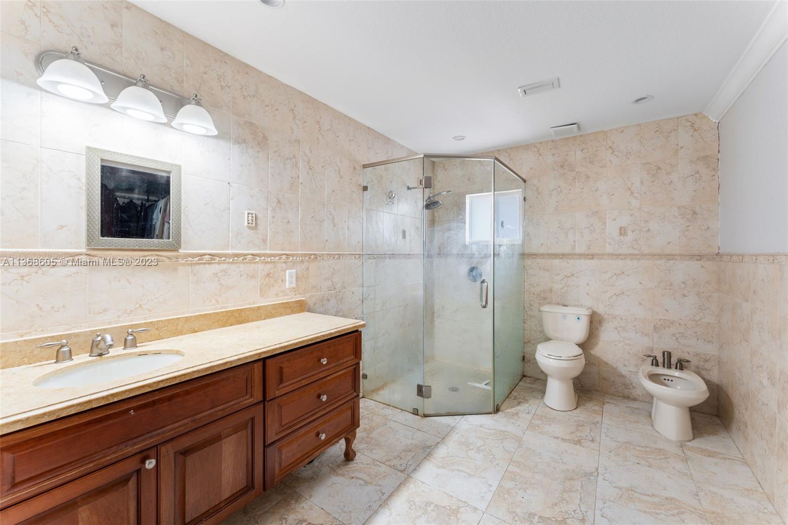 Hialeah Hialeah, FL 33014 - Photo 13 of 32 a bathroom with a sink a toilet and shower