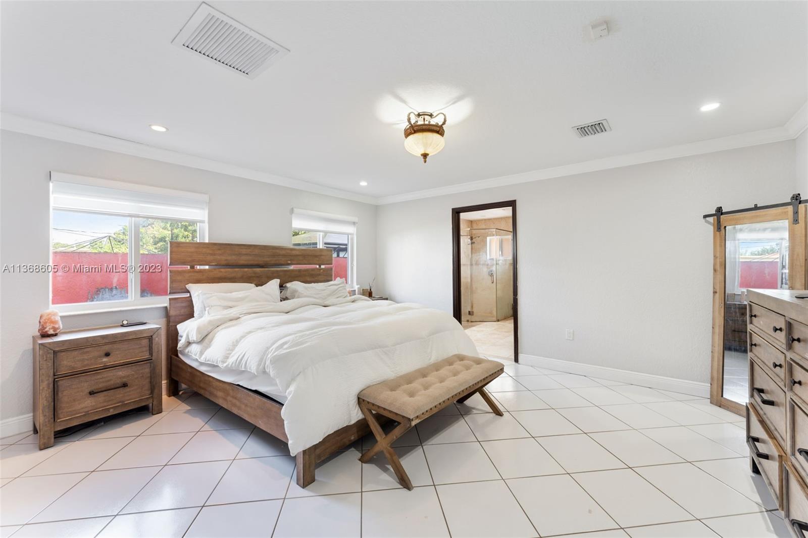 Hialeah Hialeah, FL 33014 - Photo 20 of 32 a bedroom with a bed and a chandelier