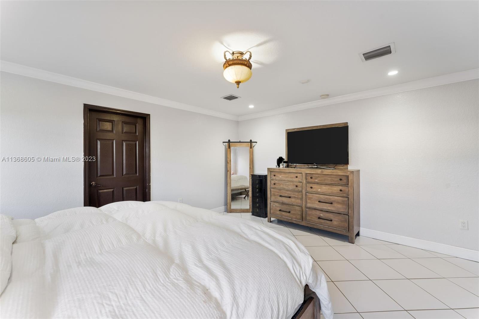 Hialeah Hialeah, FL 33014 - Photo 21 of 32 a bedroom with a bed and flat screen tv