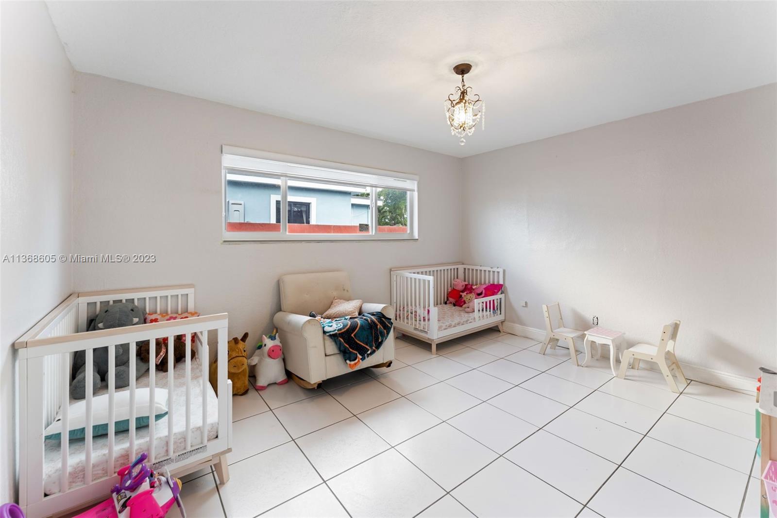 Hialeah Hialeah, FL 33014 - Photo 25 of 32 a bedroom with furniture and a chandelier