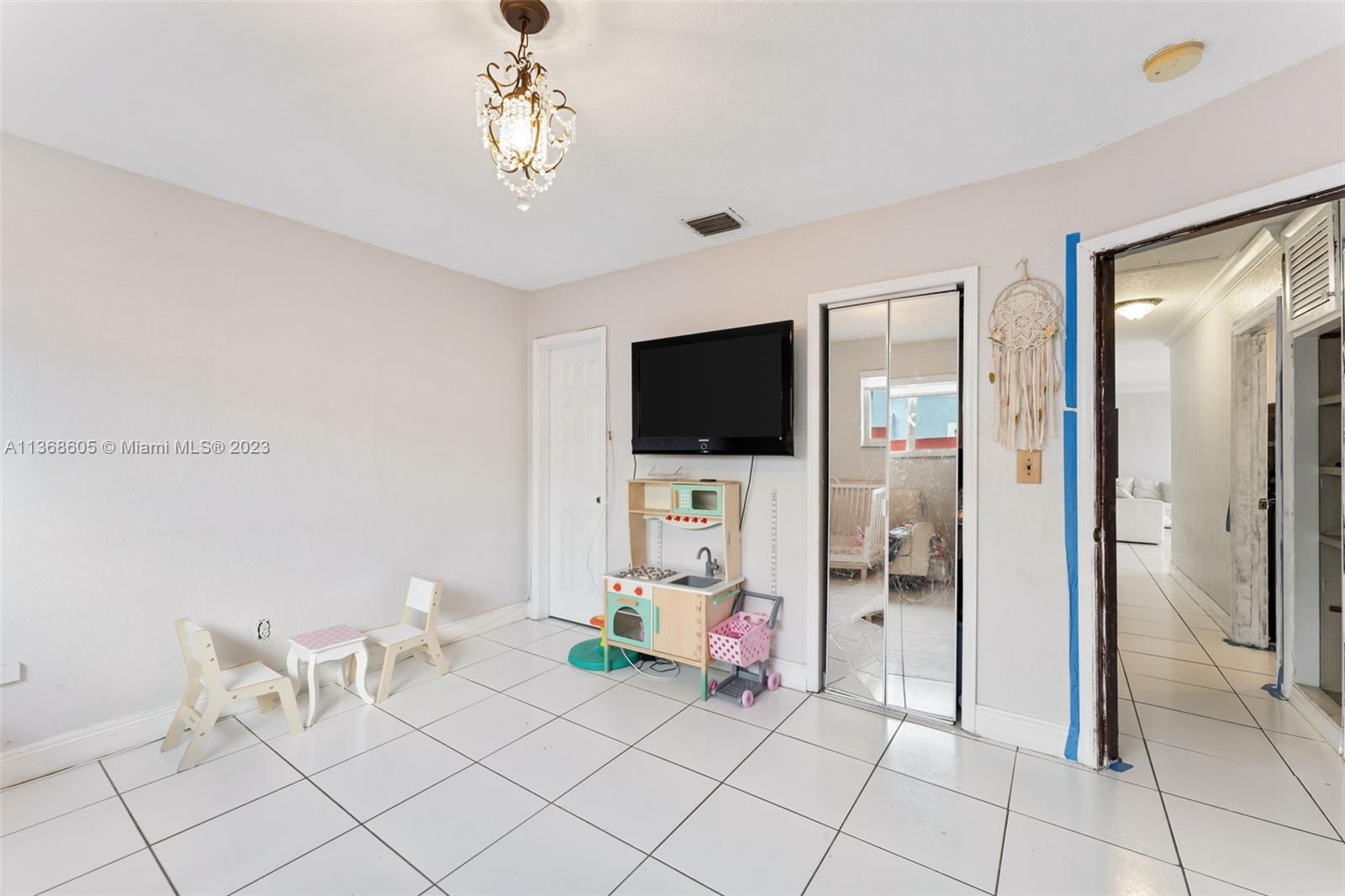 Hialeah Hialeah, FL 33014 - Photo 26 of 32 a living room with furniture and a flat screen tv