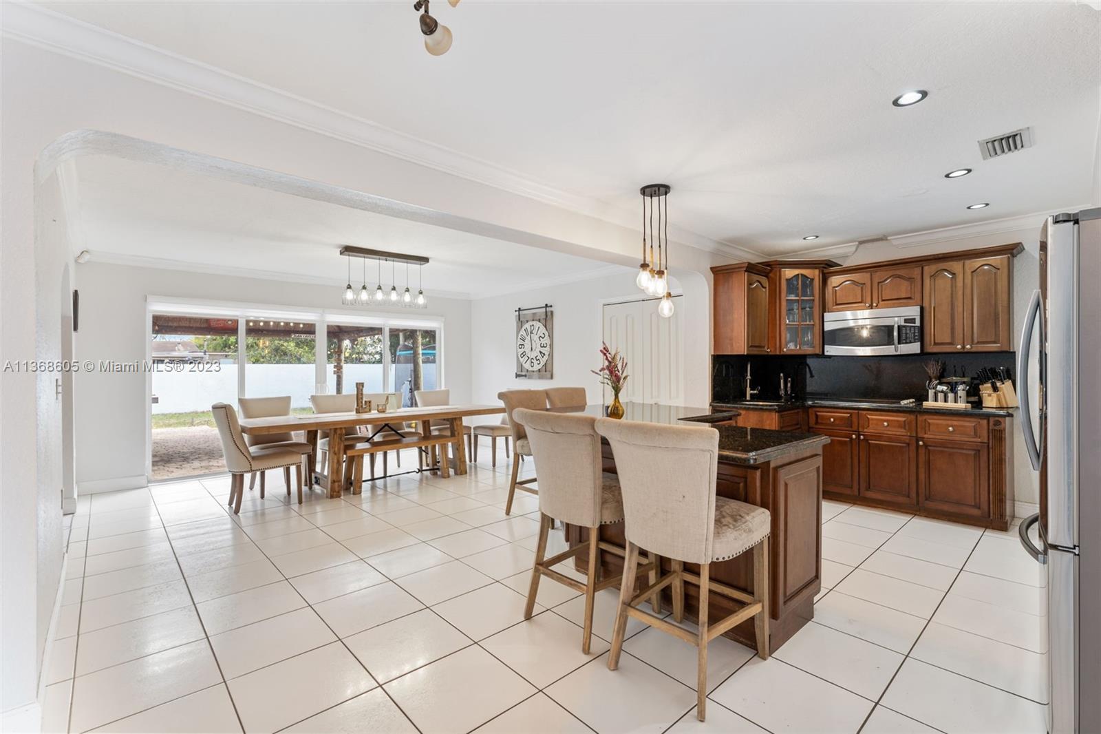 Hialeah Hialeah, FL 33014 - Photo 9 of 32 a large kitchen with a table and chairs