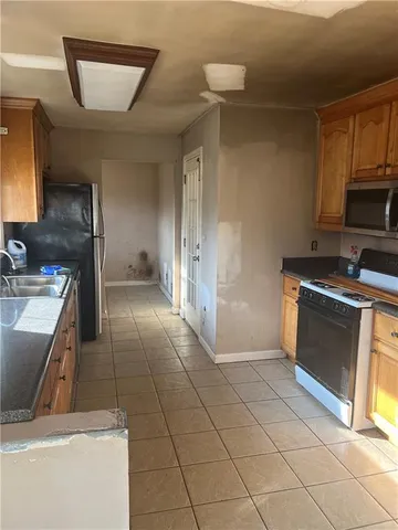 a kitchen with a sink a stove and cabinets