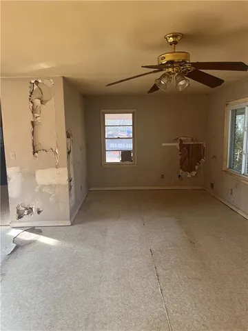 an empty room with windows and closet