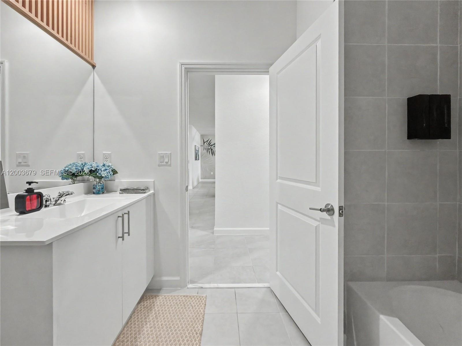 13218 Southwest 189th Terrace Miami, FL 33177 - Photo 14 of 47 a bathroom with a sink and a mirror