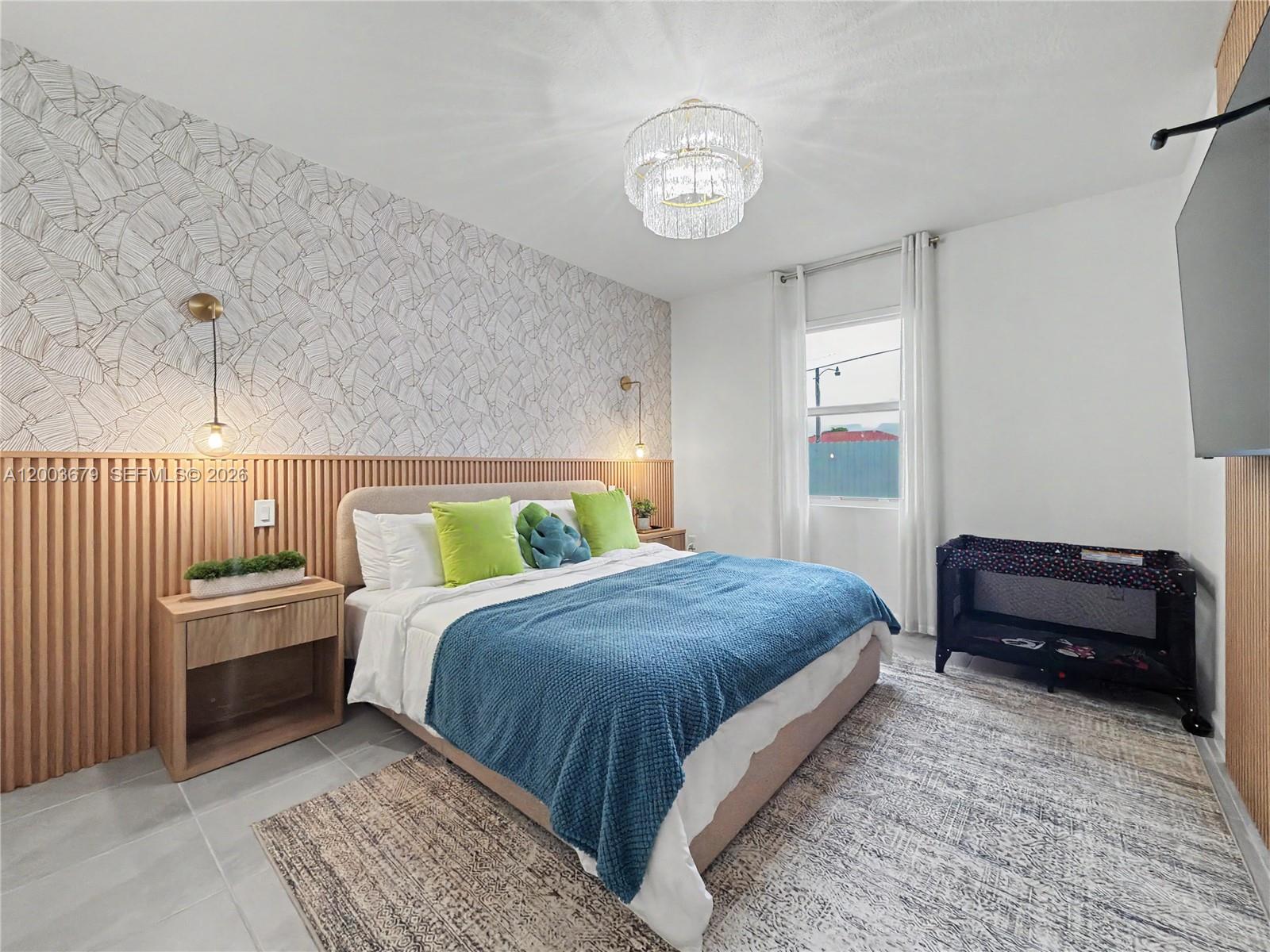 13218 Southwest 189th Terrace Miami, FL 33177 - Photo 16 of 47 a bedroom with a bed and a chandelier
