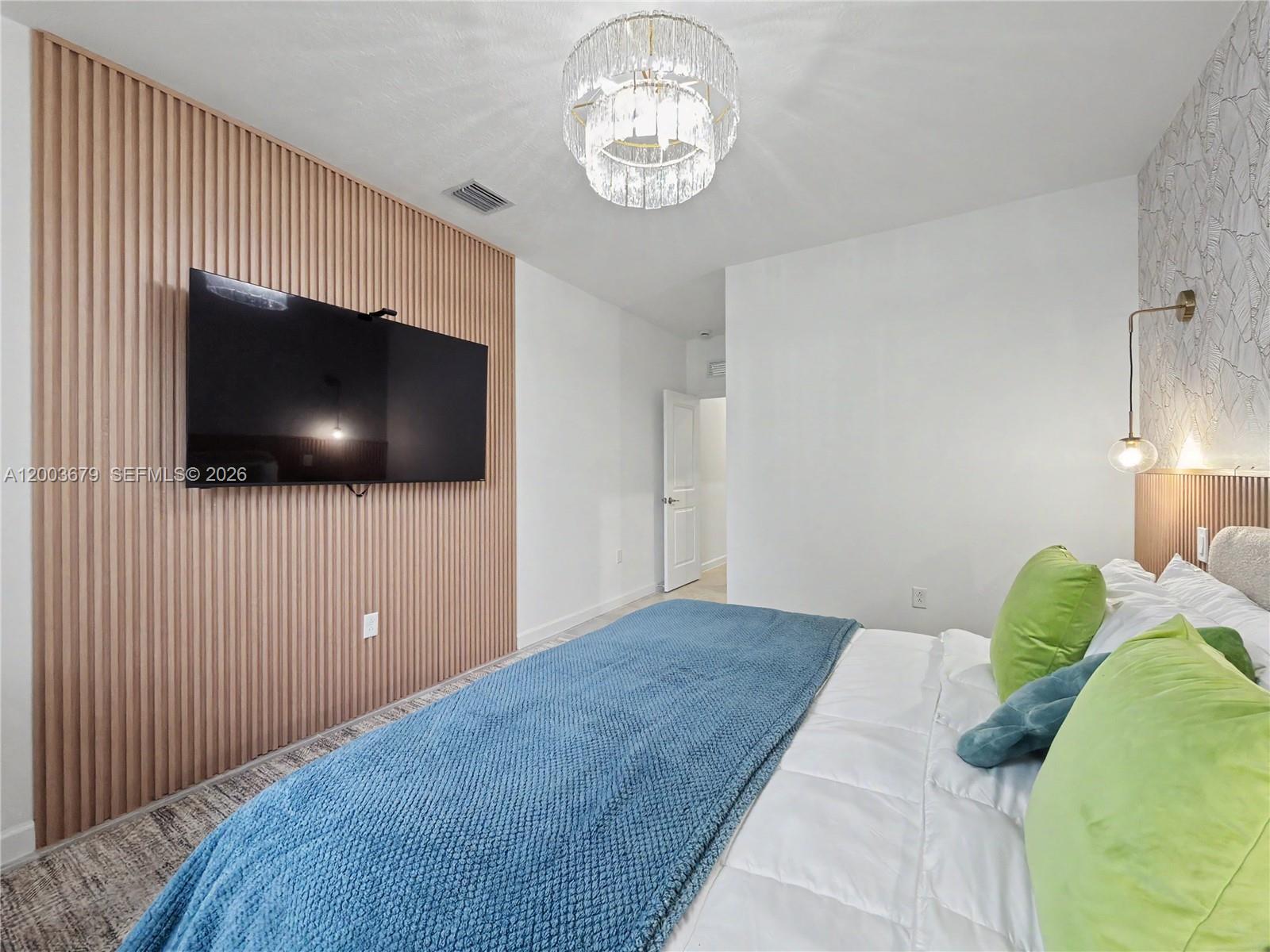 13218 Southwest 189th Terrace Miami, FL 33177 - Photo 18 of 47 a bedroom with a bed and a flat screen tv