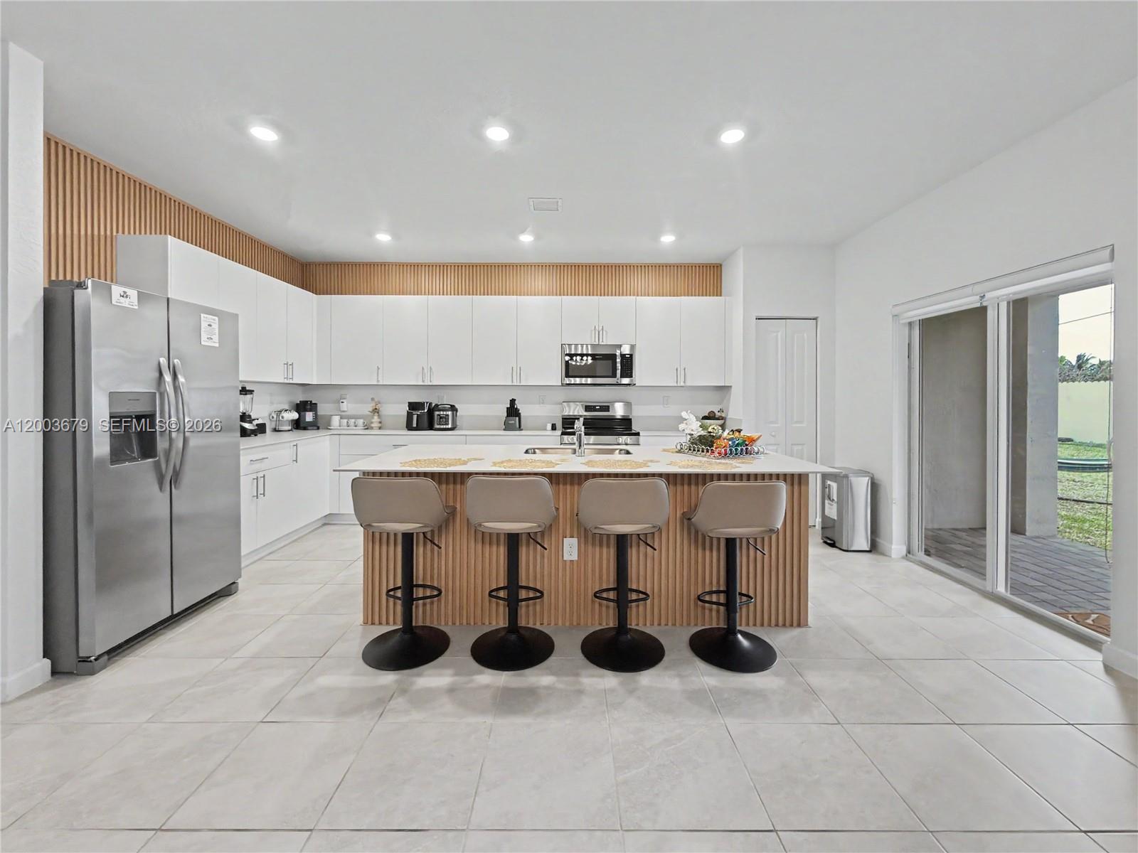 13218 Southwest 189th Terrace Miami, FL 33177 - Photo 2 of 47 a kitchen with stainless steel appliances granite countertop a sink a counter and cabinets