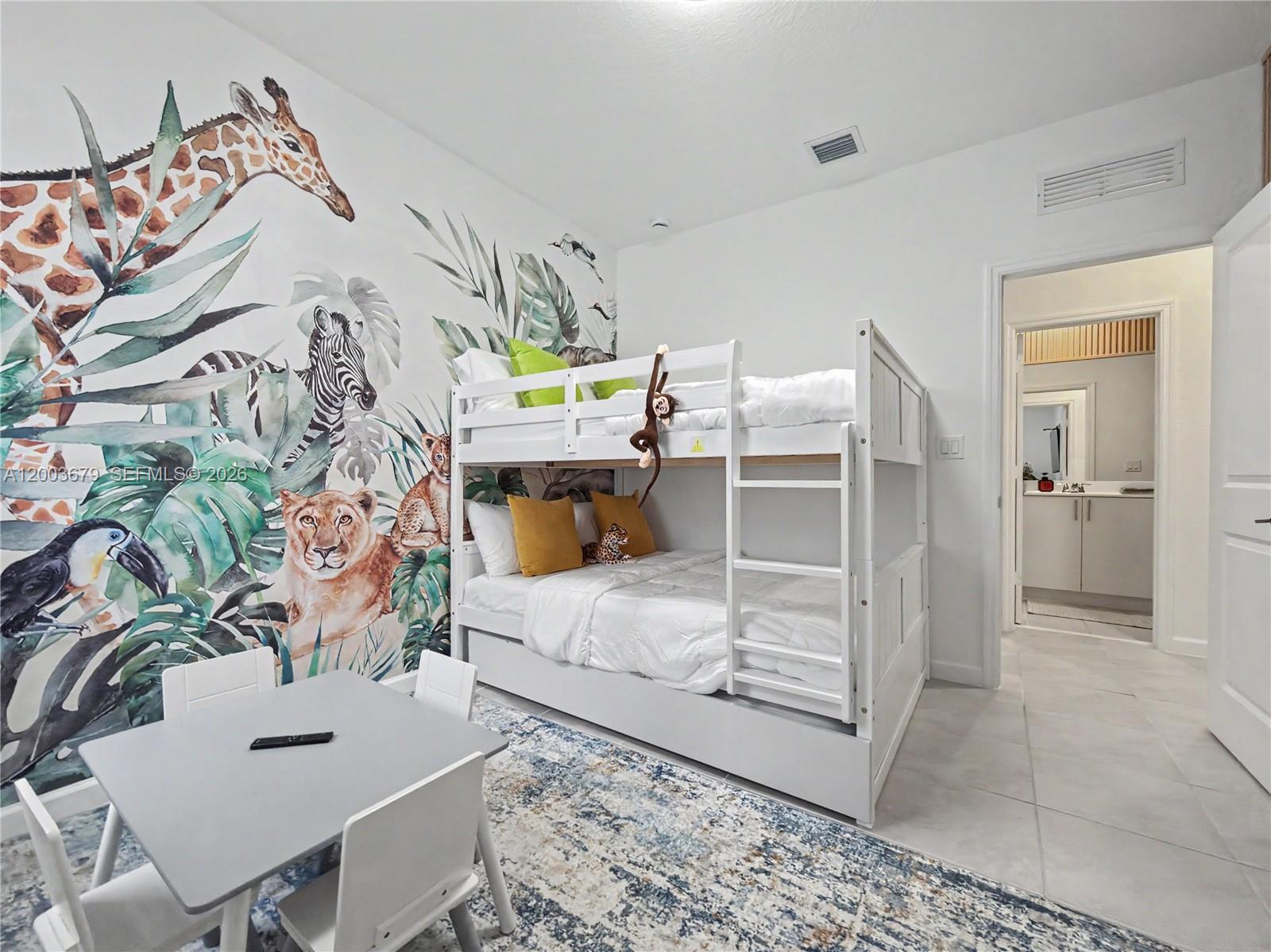 13218 Southwest 189th Terrace Miami, FL 33177 - Photo 27 of 47 a bedroom with a bed and a table in it