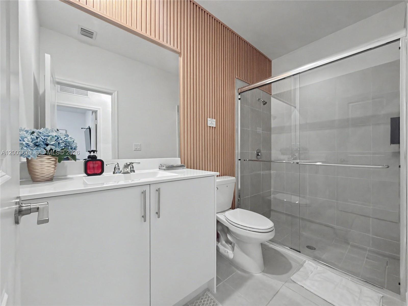 13218 Southwest 189th Terrace Miami, FL 33177 - Photo 29 of 47 a bathroom with a sink mirror toilet and shower