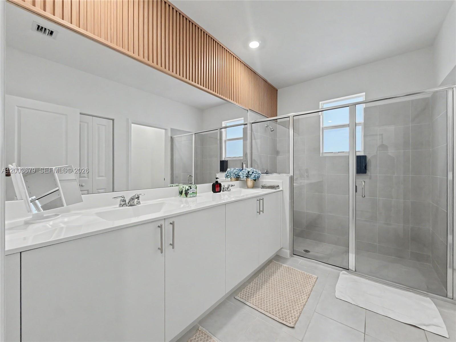 13218 Southwest 189th Terrace Miami, FL 33177 - Photo 31 of 47 a bathroom with a double vanity sink mirror and shower