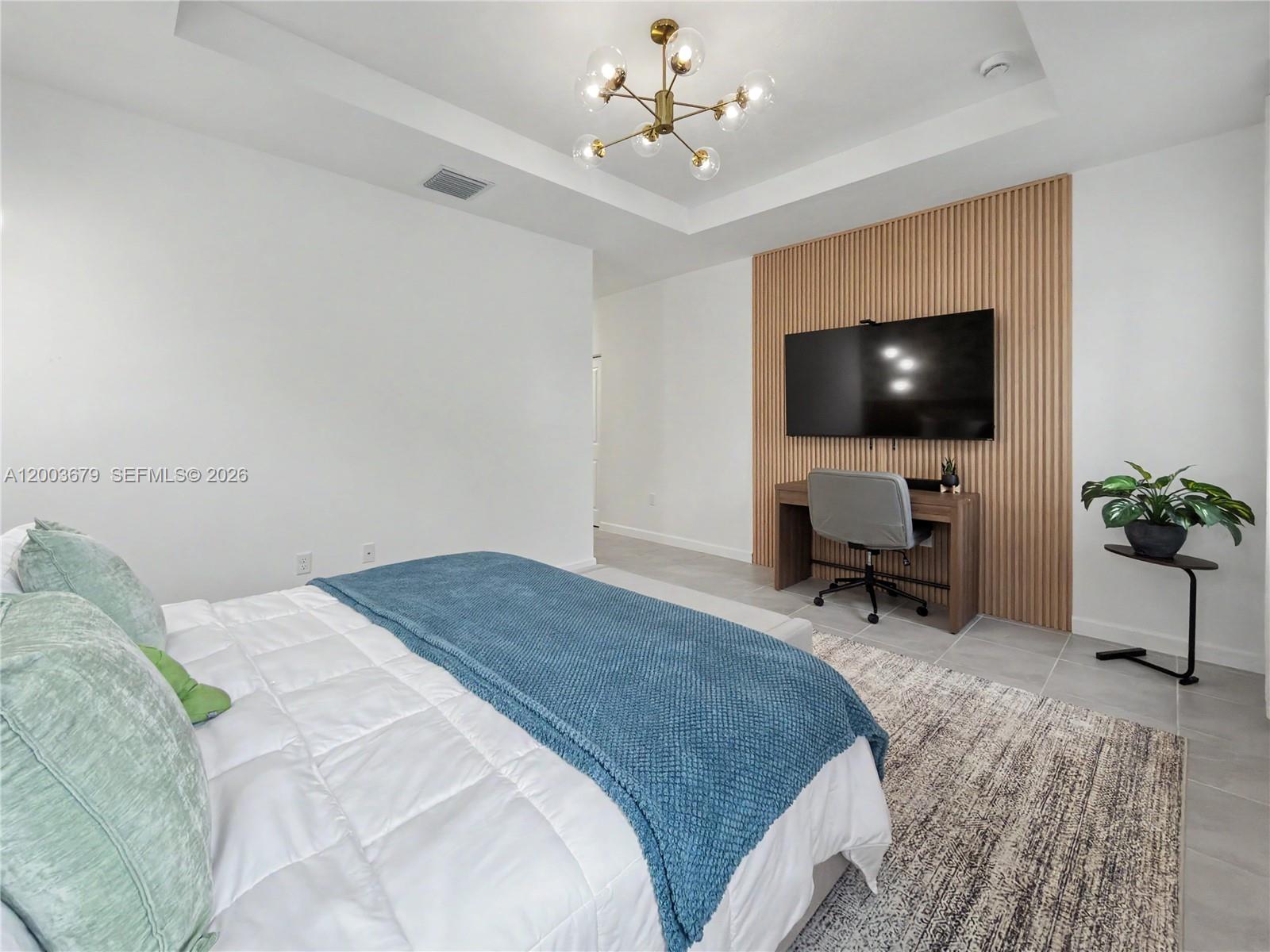 13218 Southwest 189th Terrace Miami, FL 33177 - Photo 36 of 47 a spacious bedroom with a bed and a a flat screen tv
