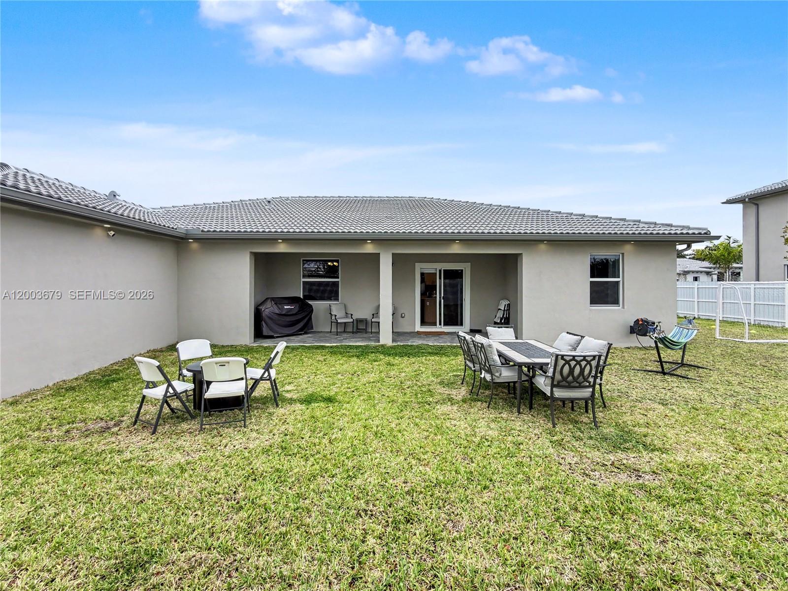 13218 Southwest 189th Terrace Miami, FL 33177 - Photo 42 of 47 a view of a house with backyard sitting area and garden