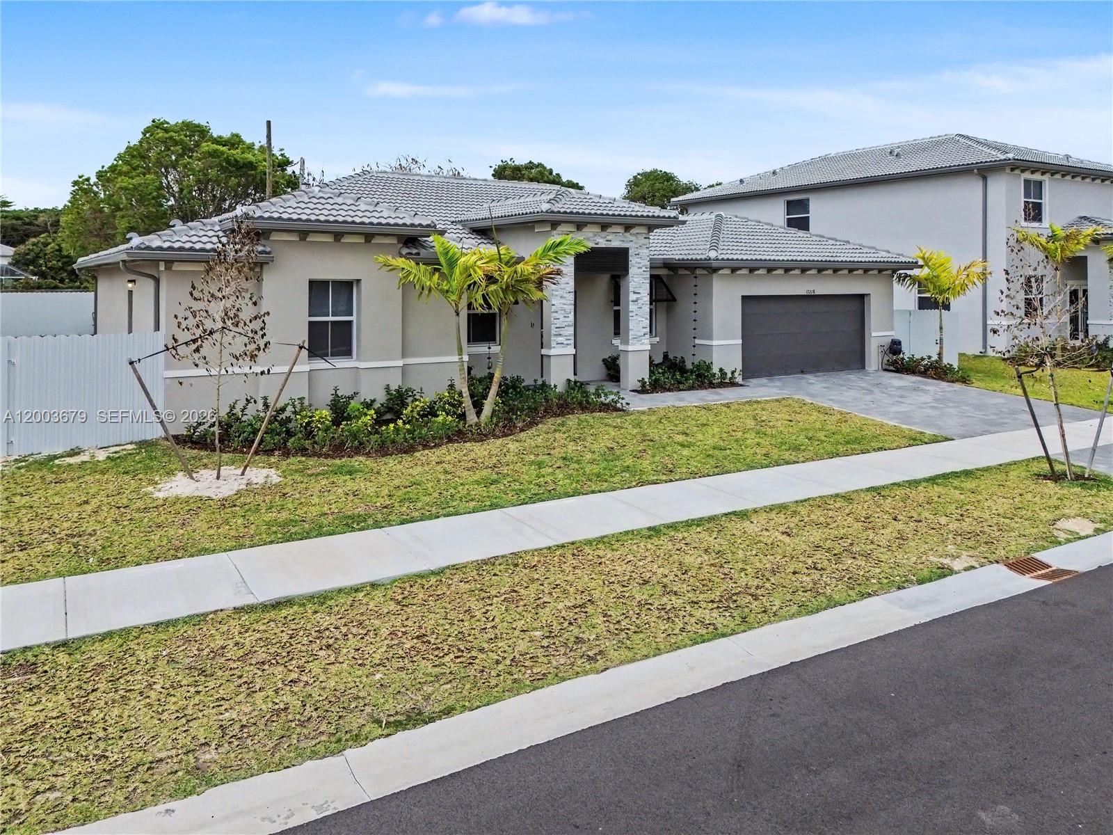 13218 Southwest 189th Terrace Miami, FL 33177 - Photo 47 of 47 a front view of a house with a garden and yard
