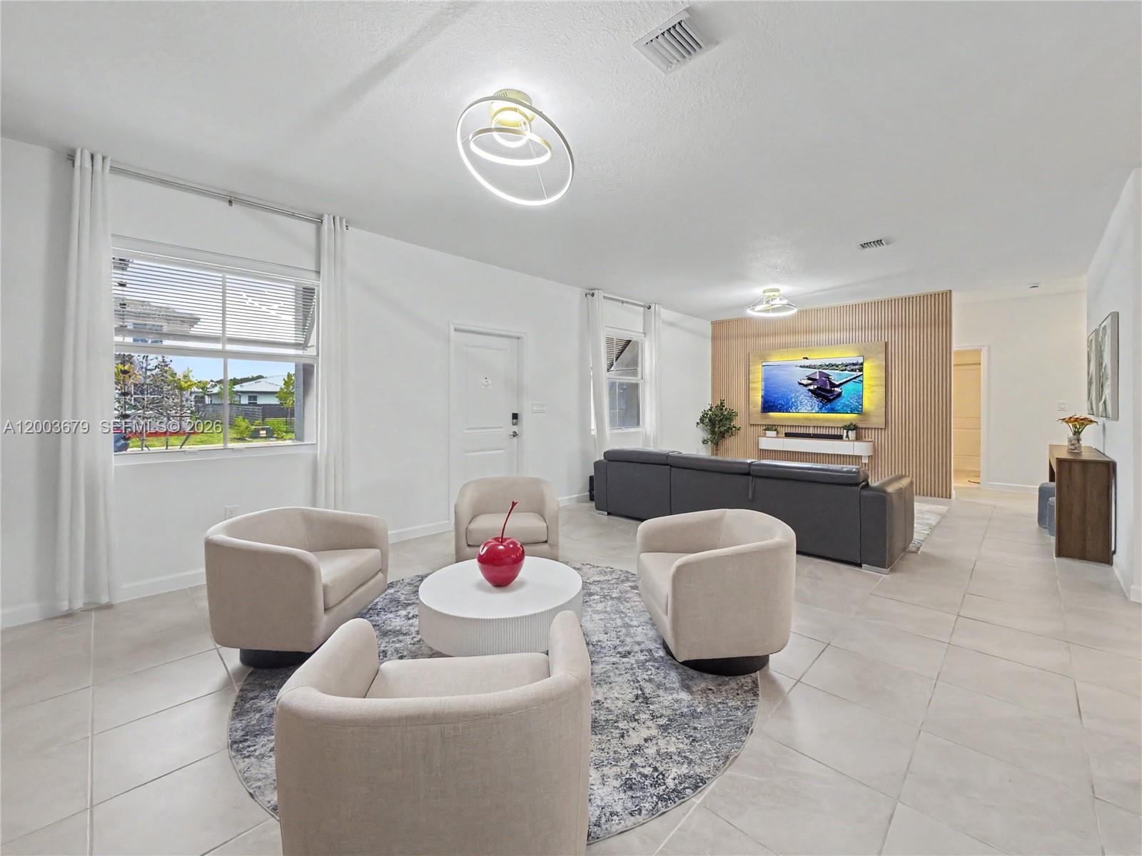 13218 Southwest 189th Terrace Miami, FL 33177 - Photo 5 of 47 a living room with furniture and a window