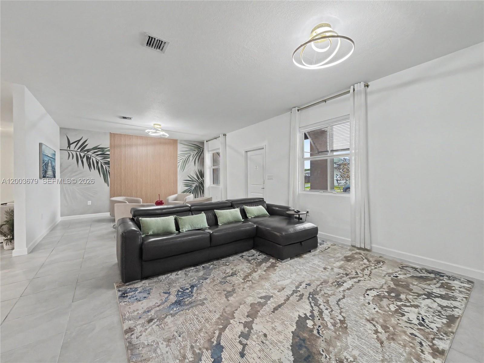 13218 Southwest 189th Terrace Miami, FL 33177 - Photo 9 of 47 a living room with a couch and a window
