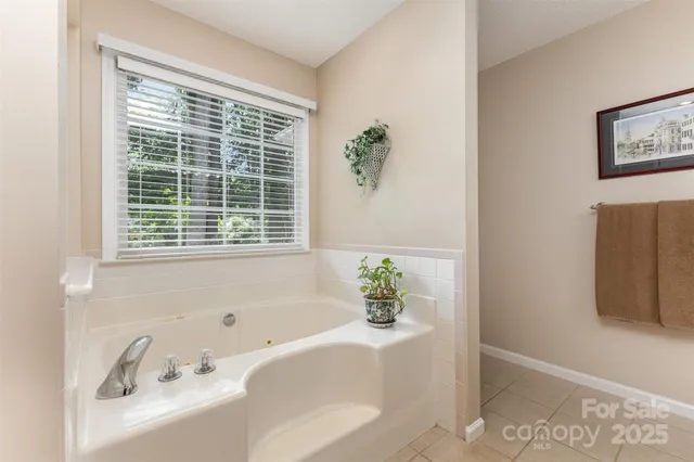a bath tub sitting in a bathroom next to a window