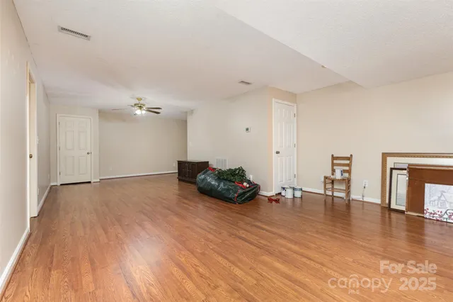 a room with wooden floor and furniture