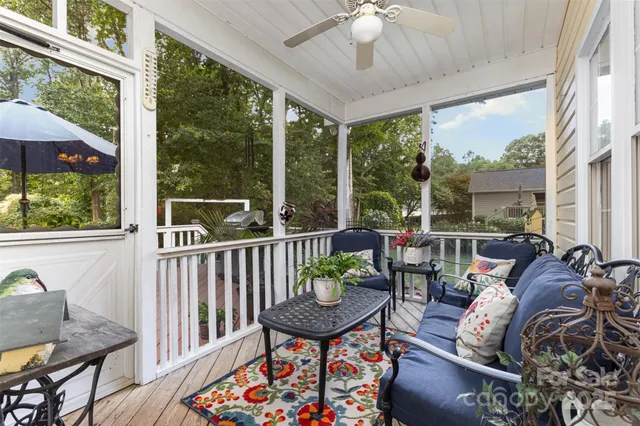 a view of a porch with furniture and a yard