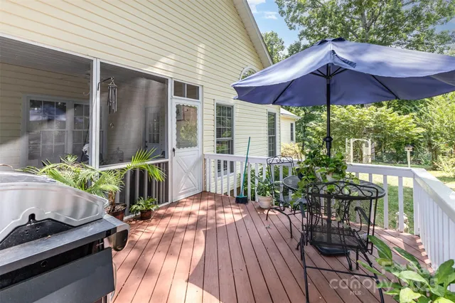 a view of balcony with chairs and wooden floor