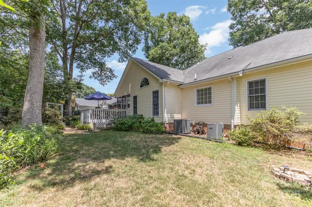 a view of a house with a yard and potted plants