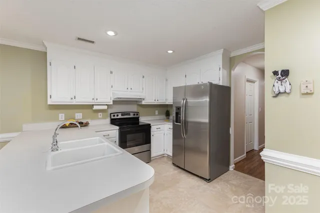 a kitchen with a refrigerator sink and stove