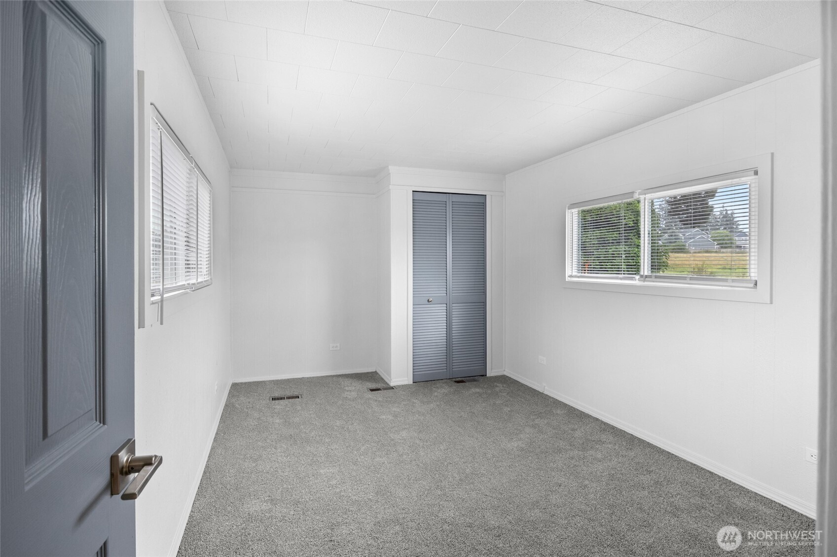 8915 Wilkensen Road Southeast, Unit 3 Yelm, WA 98597 - Photo 13 of 16 an empty room with windows