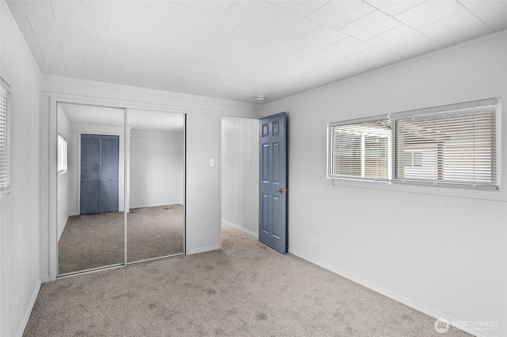 8915 Wilkensen Road Southeast, Unit 3 Yelm, WA 98597 - Photo 15 of 16 an empty room with windows and closet