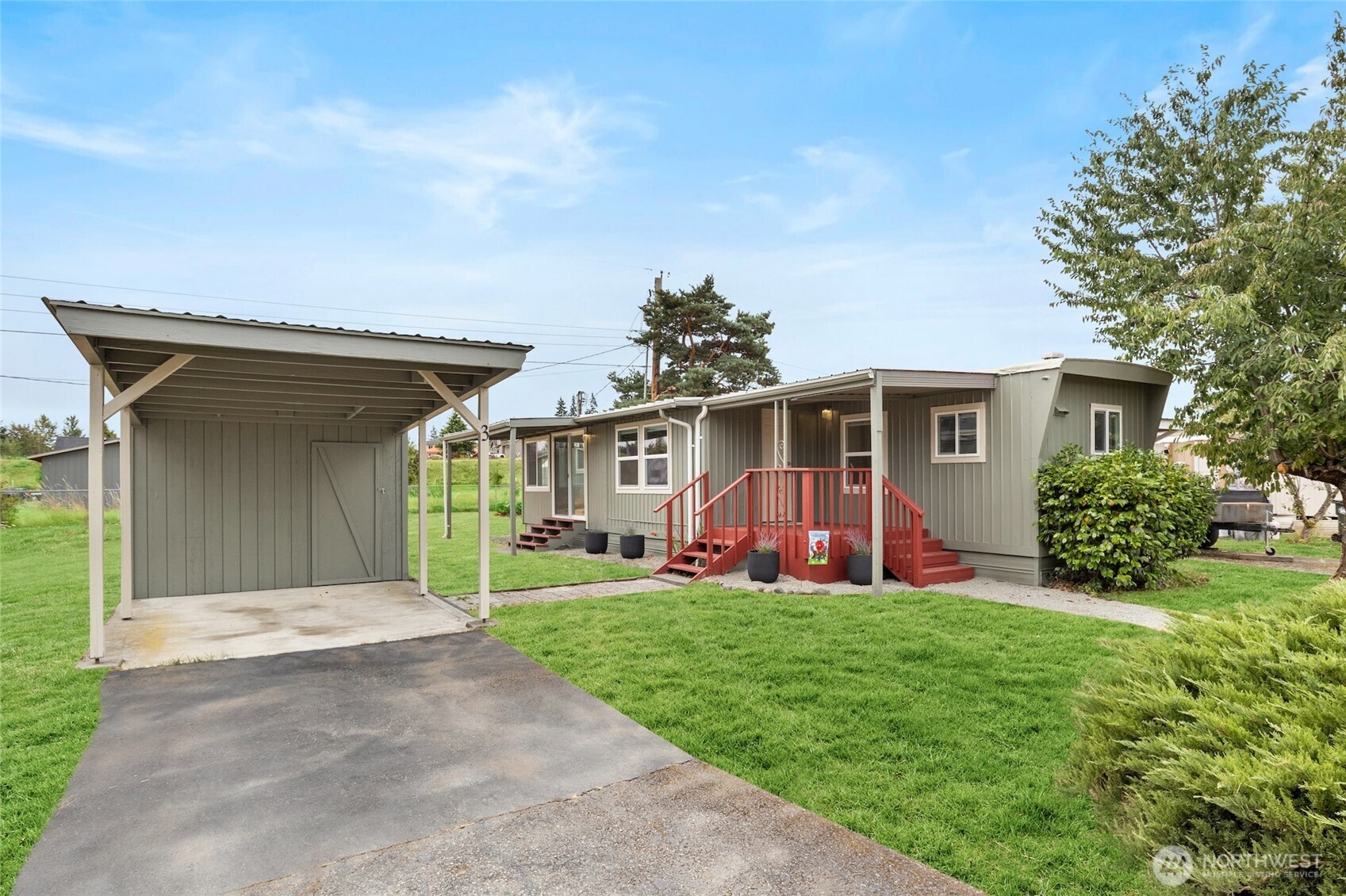 8915 Wilkensen Road Southeast, Unit 3 Yelm, WA 98597 - Photo 2 of 16 front view of a house with a yard