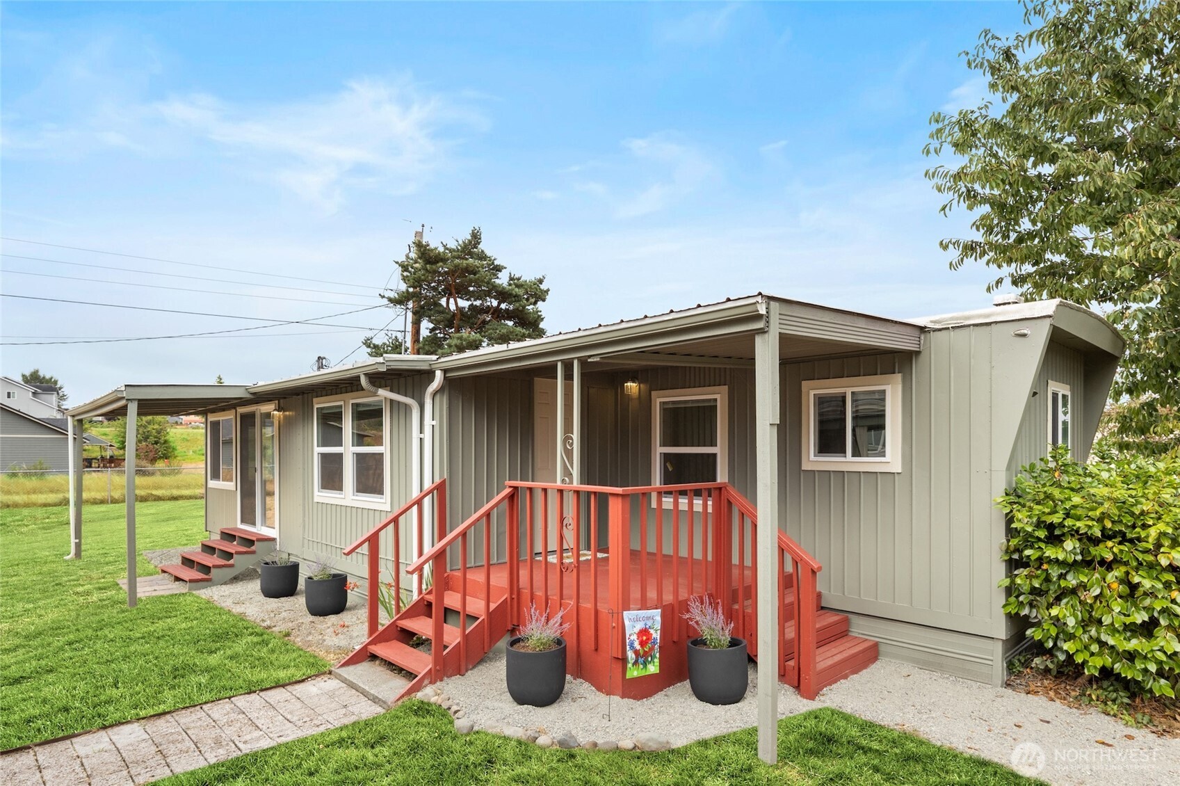 8915 Wilkensen Road Southeast, Unit 3 Yelm, WA 98597 - Photo 3 of 16 a view of a house with a yard