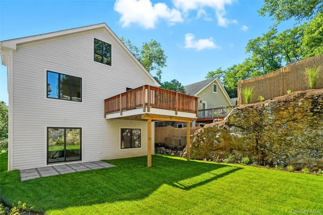 a view of a house with a yard porch and sitting area