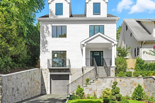 a front view of a house with a garden