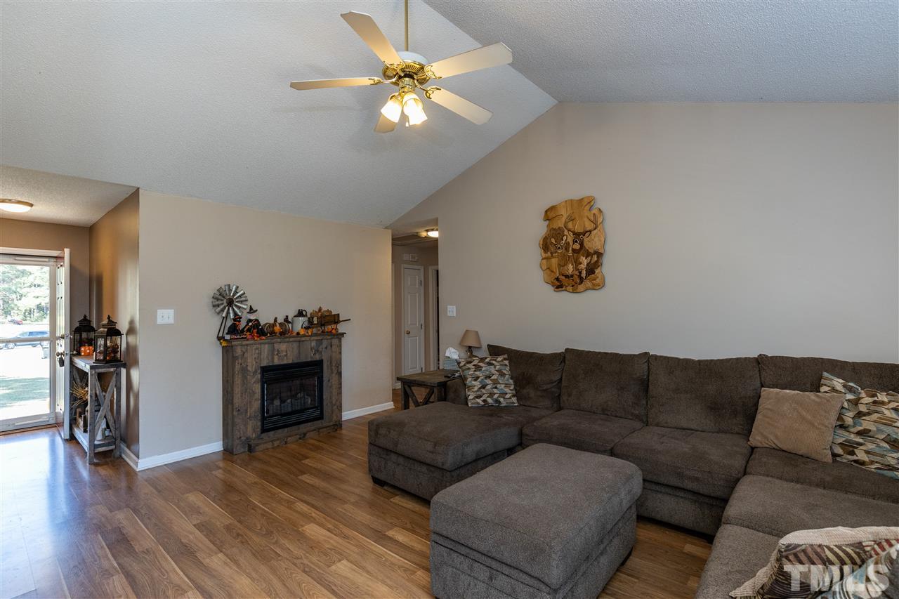 103 Holly Ranch Court Willow Spring, NC 27592 - Photo 11 of 30 a living room with furniture and a fireplace