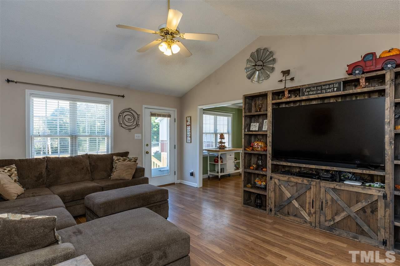 103 Holly Ranch Court Willow Spring, NC 27592 - Photo 13 of 30 a living room with furniture and a flat screen tv