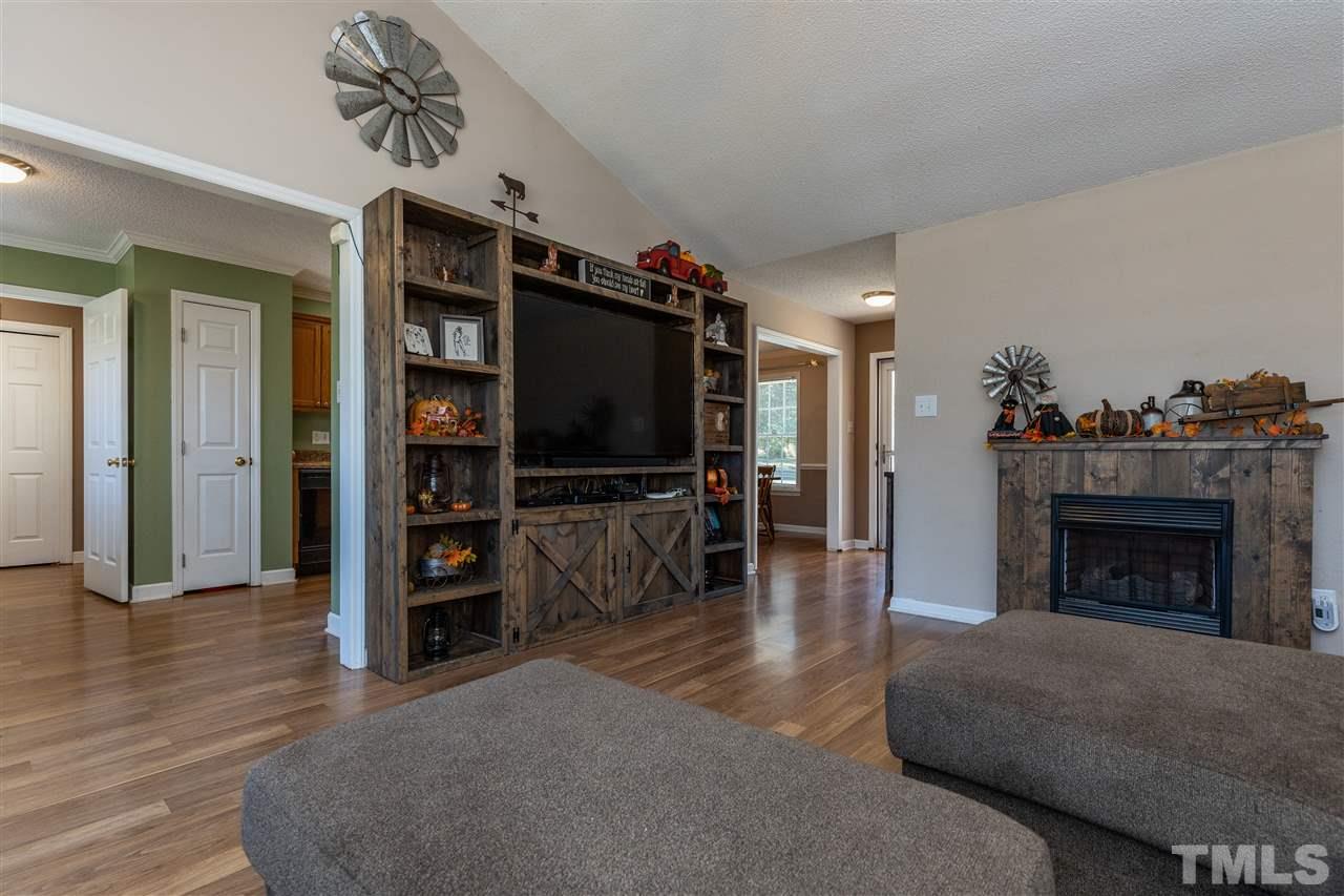 103 Holly Ranch Court Willow Spring, NC 27592 - Photo 14 of 30 a living room with furniture and a fireplace