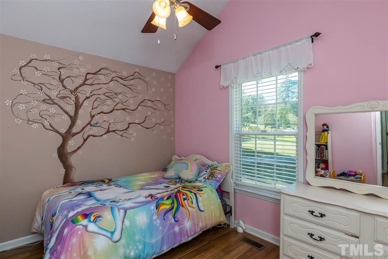 103 Holly Ranch Court Willow Spring, NC 27592 - Photo 15 of 30 a bedroom with a bed and a dresser in it