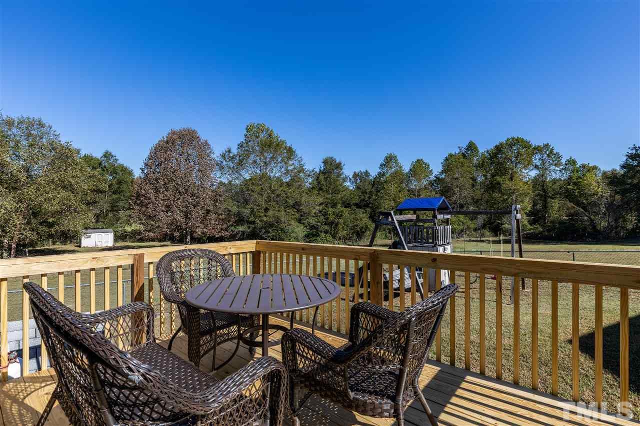103 Holly Ranch Court Willow Spring, NC 27592 - Photo 24 of 30 a view of balcony with furniture and trees in the background