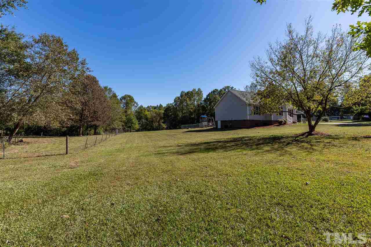 103 Holly Ranch Court Willow Spring, NC 27592 - Photo 29 of 30 a view of a yard with a house in the background