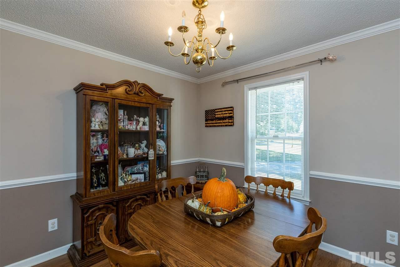 103 Holly Ranch Court Willow Spring, NC 27592 - Photo 6 of 30 a living room with furniture and a chandelier