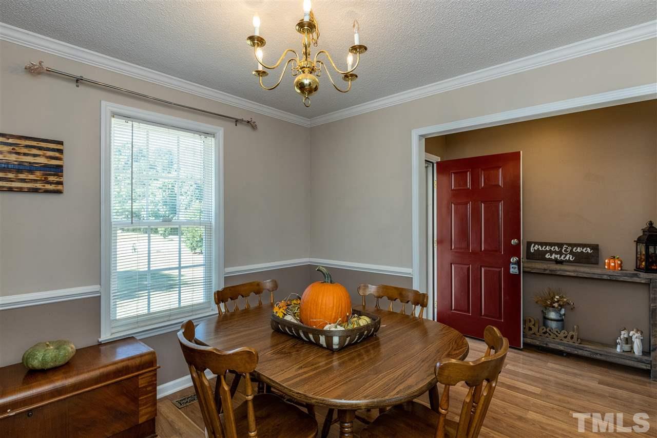 103 Holly Ranch Court Willow Spring, NC 27592 - Photo 7 of 30 a view of a dining room with furniture and chandelier