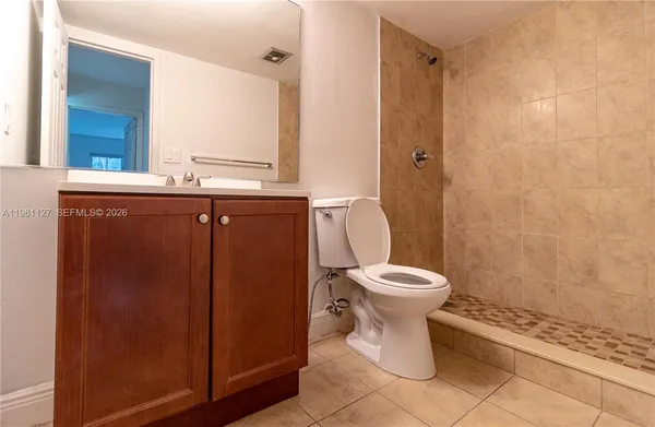 a bathroom with a toilet sink and shower