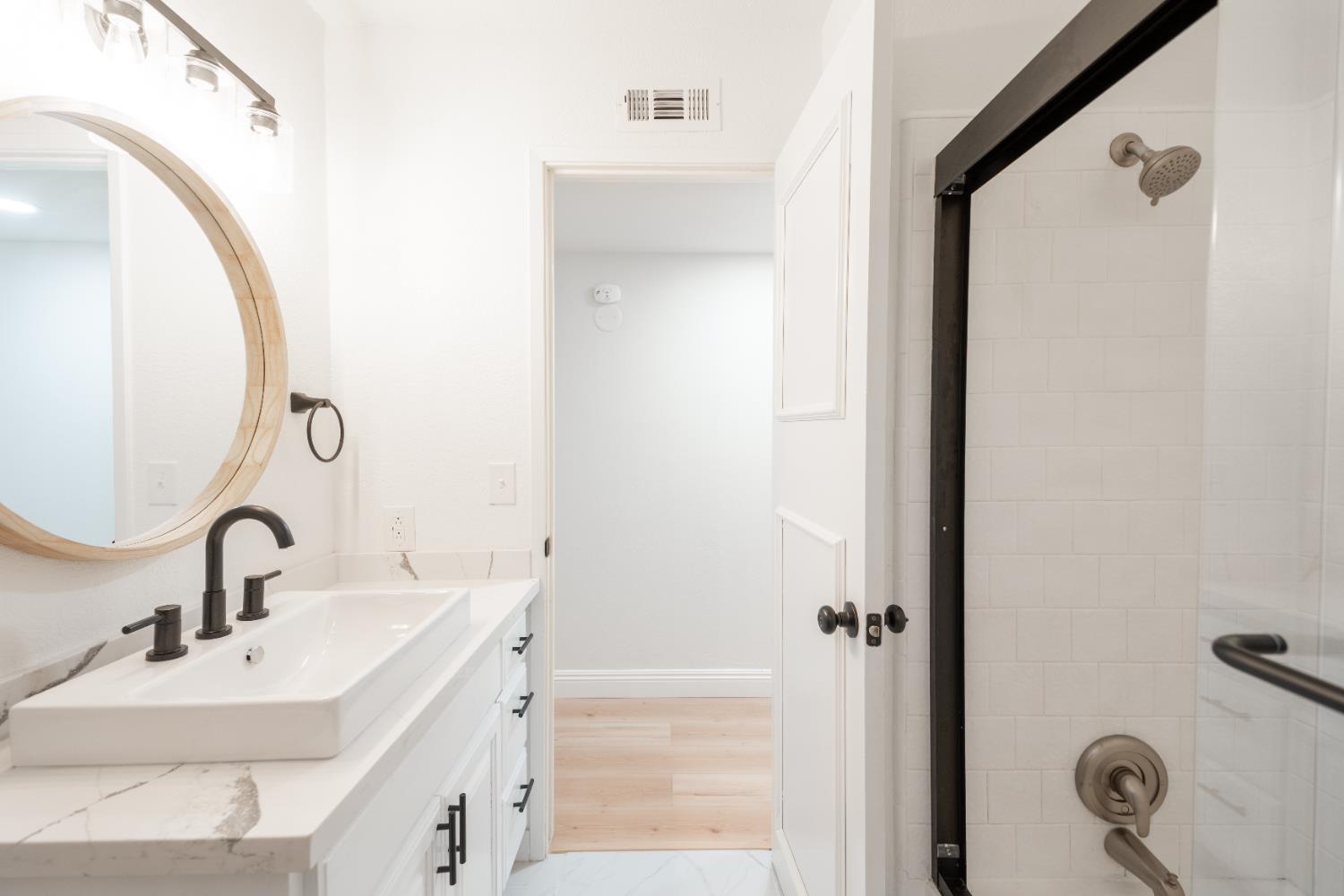 2612 Renn Avenue Clovis, CA 93611 - Photo 16 of 36 a bathroom with a sink and mirror