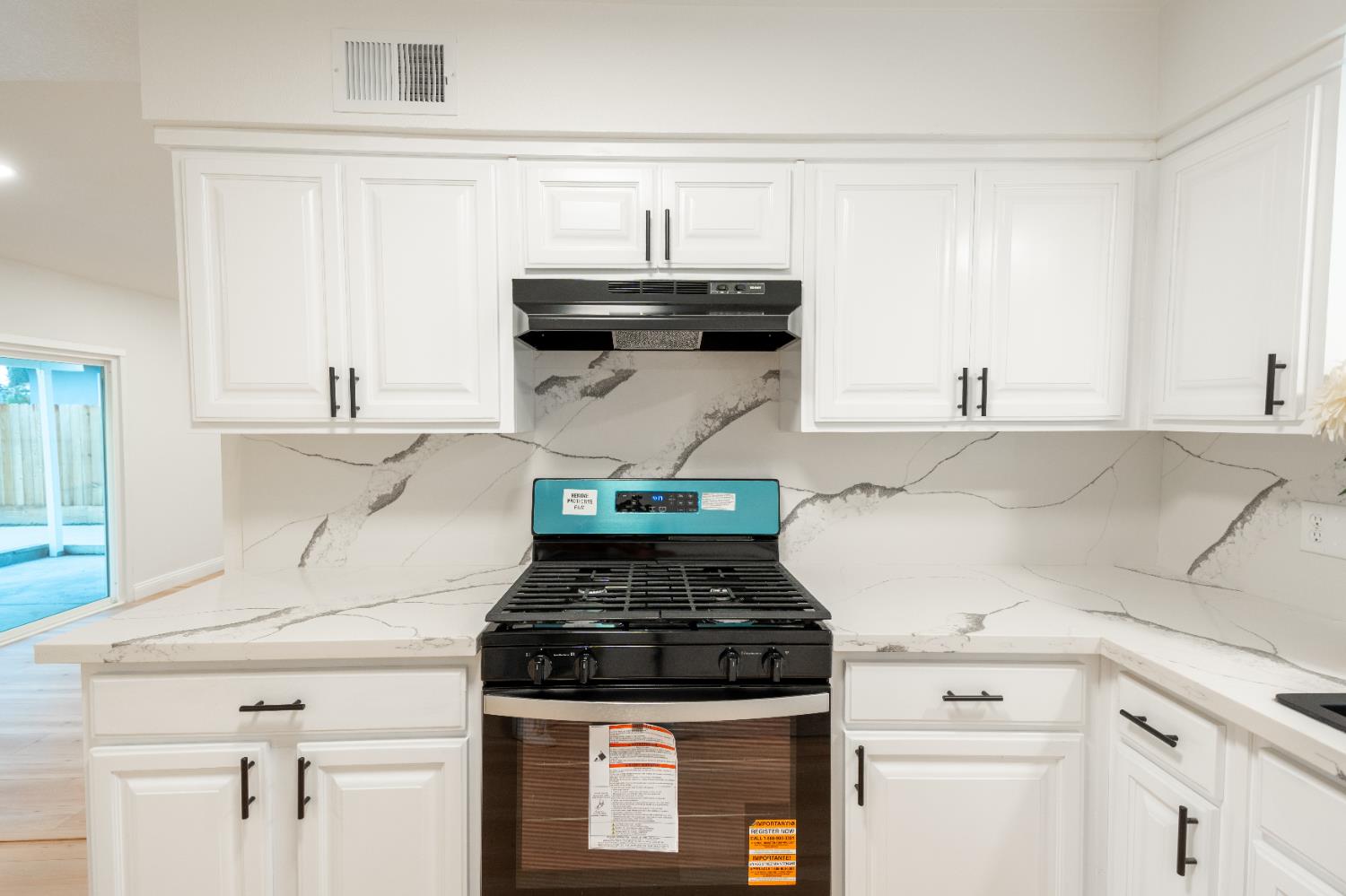 2612 Renn Avenue Clovis, CA 93611 - Photo 6 of 36 a white stove top oven sitting inside of a kitchen